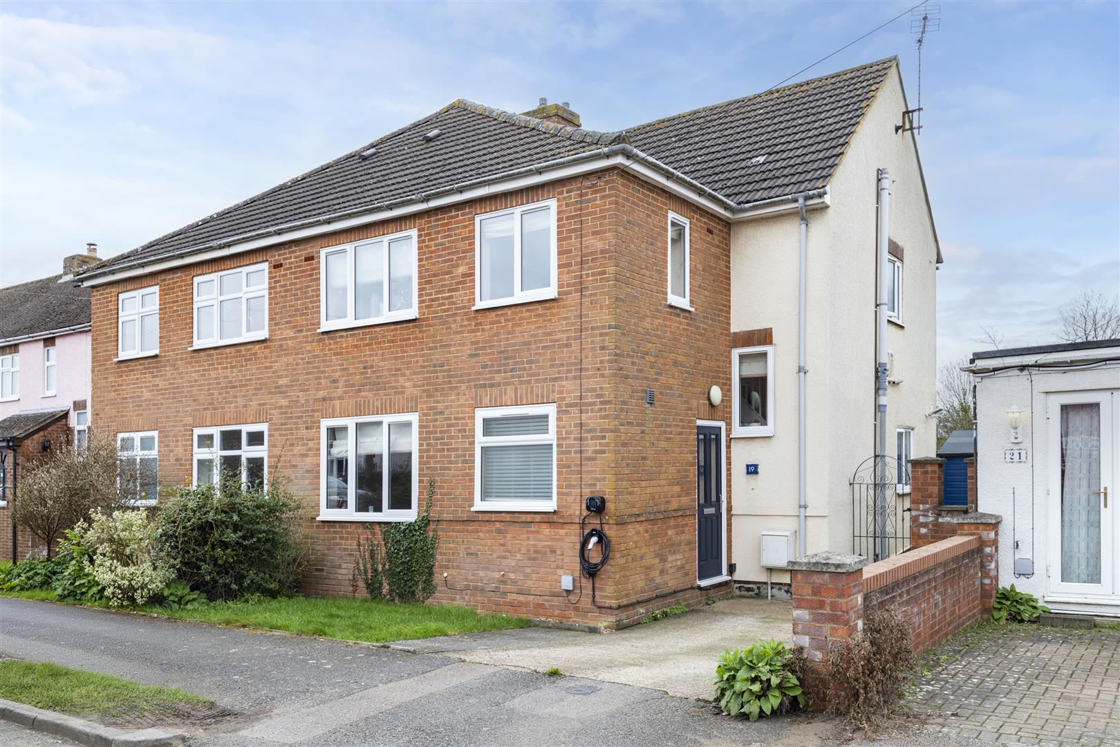Brick semi-detached house with front garden.